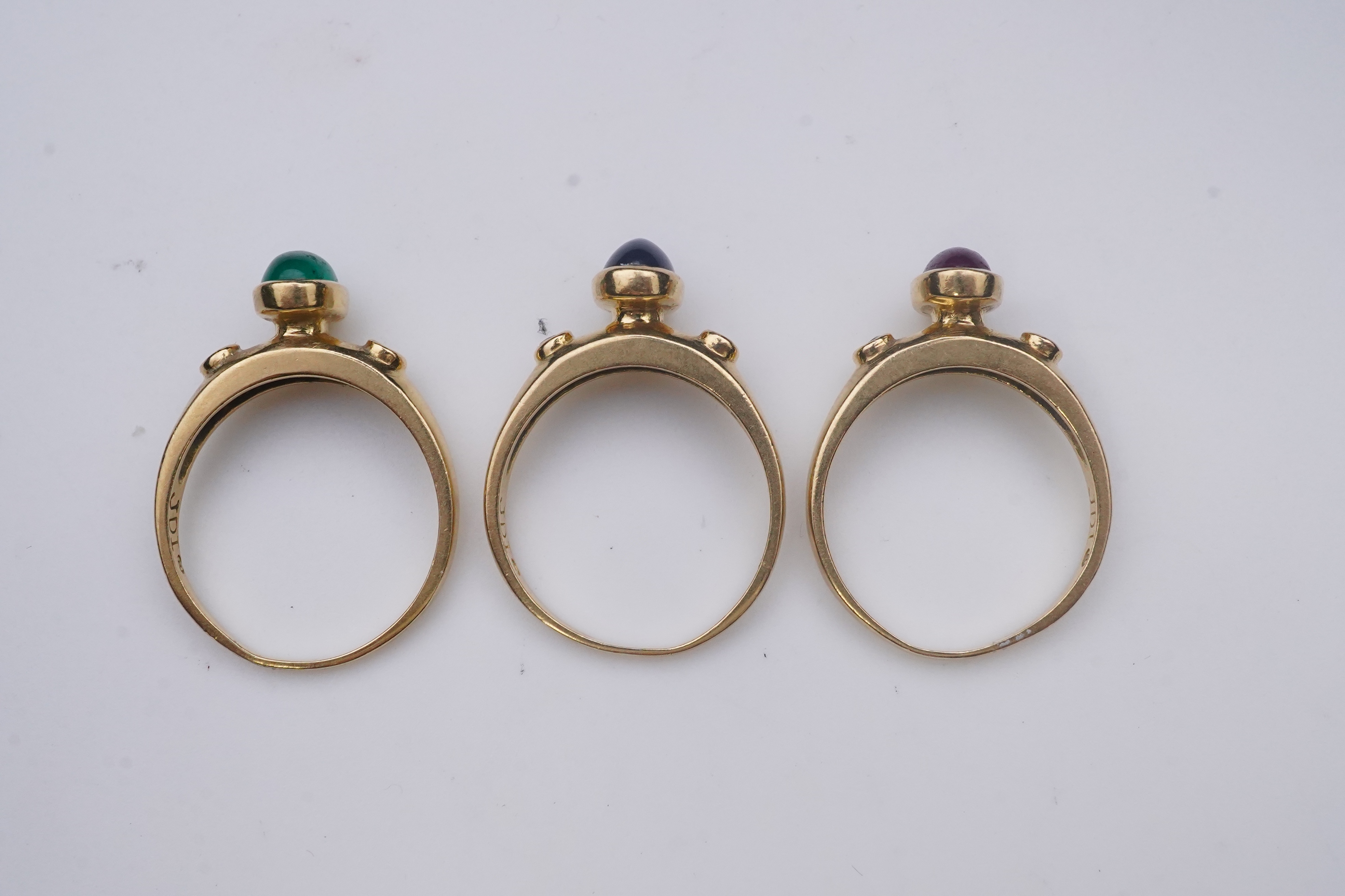 A suite of three gold and gem-set rings